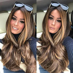 Side-by-side selfies of a woman seated in a car, wearing a dark top and seatbelt, with long wavy brown hair featuring blonde highlights and sunglasses resting on her head.