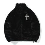 Black fluffy zip-up jacket with high collar, elasticated hem and white cross detail on the chest.
