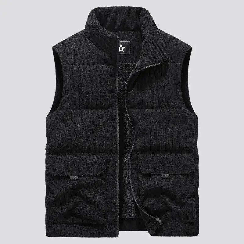 A stylish sleeveless puffer vest made of soft corduroy fabric. The vest features a high collar for added warmth and a cozy fleece lining. It has two large front pockets with flap closures, adding both functionality and a rugged aesthetic. The vest is open in the image, showcasing the plush inner lining