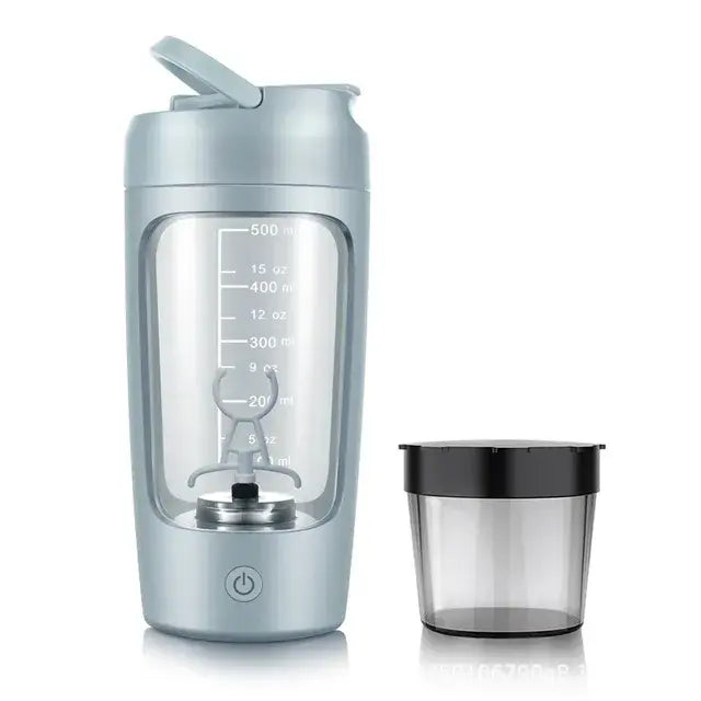 A portable blender bottle with a transparent body showing measurement markings, and a small container beside it. The bottle has a lid and an on/off button.