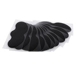 Set of black adhesive patches on a white background