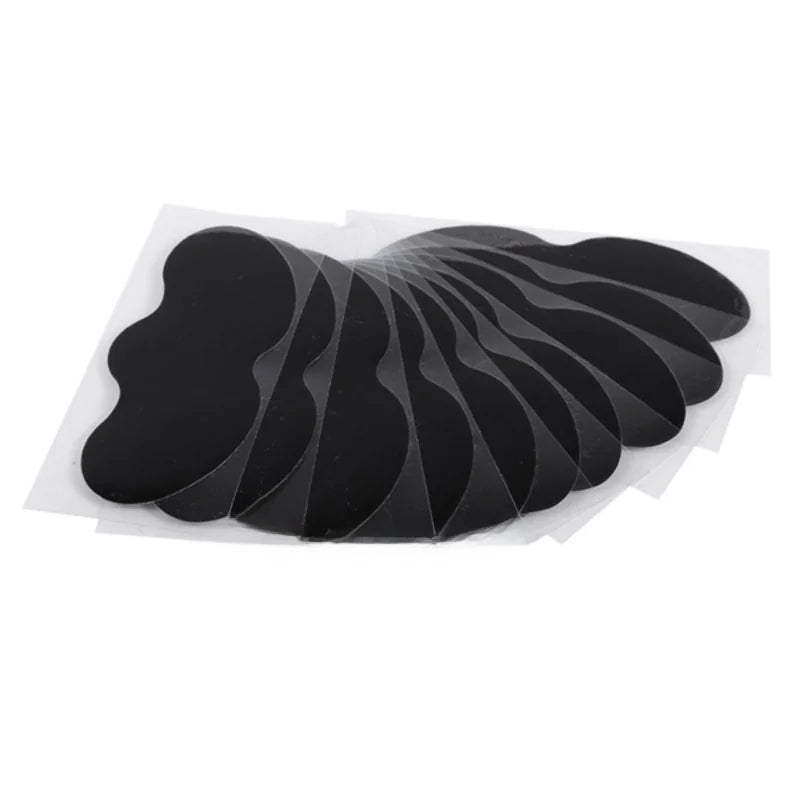 Set of black adhesive patches on a white background