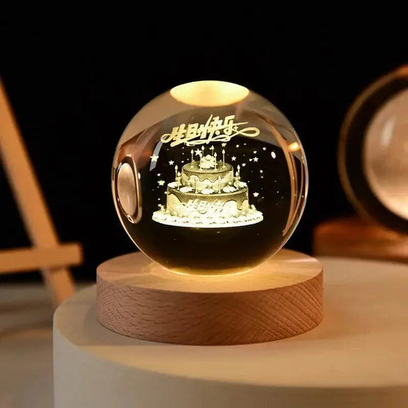 Glowing crystal ball night light on a wooden base with an etched “Happy Birthday” cake and stars inside.