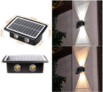 Solar-powered wall light with dual LEDs and size measurements, plus photos showing the light casting up-and-down beams on an exterior wall.