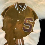 Brown and cream varsity jacket with letter patch.
