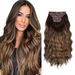 A brunette model with long, wavy hair featuring caramel-blonde highlights is shown next to a matching clip-in hair extension piece with a layered clip base and soft waves.