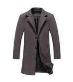 A stylish men's overcoat with a slim-fit design, featuring a three-button front closure and a notched lapel. The coat is made from a smooth fabric with a slightly structured silhouette and has a black inner lining visible from the slightly open front. The long sleeves and mid-thigh length add to its formal and sophisticated look.