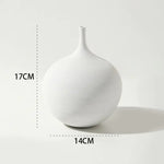 White minimalist round vase with a narrow neck and subtle textured surface, shown with dimensions of 17 cm tall and 14 cm wide.