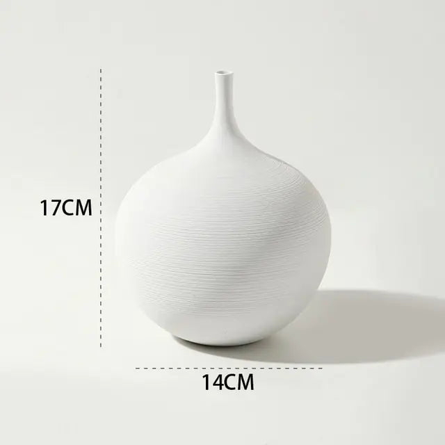 White minimalist round vase with a narrow neck and subtle textured surface, shown with dimensions of 17 cm tall and 14 cm wide.