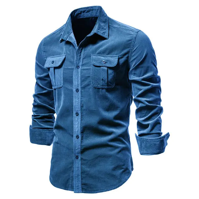 A stylish navy blue long-sleeved button-up shirt with a classic collar. The shirt features two symmetrical chest pockets with buttoned flaps, giving it a rugged yet sophisticated look. The sleeves are slightly rolled up, adding a casual touch to the overall design.