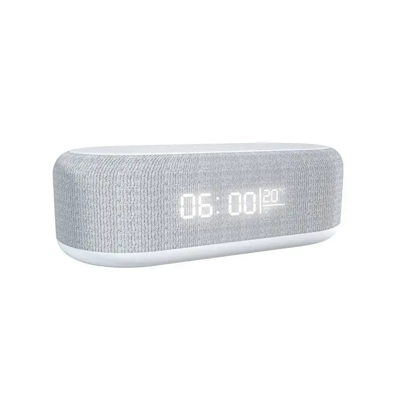 Gray fabric-covered digital alarm clock with a white base, displaying “05:00” and “20°C,” shown on a white background.