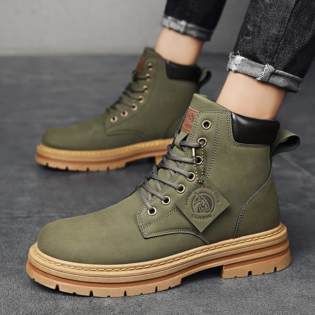 A pair of tan high-top boots with a thick jute-wrapped sole and colorful teddy bear patchwork fabric on the sides. The boots have a rugged design with metal eyelets and a branded patch on the side, displayed against a warm brown background.