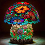 Colourful mushroom-shaped decorative lamp with a stained-glass look, covered in bright floral patterns and glowing multicoloured light.
