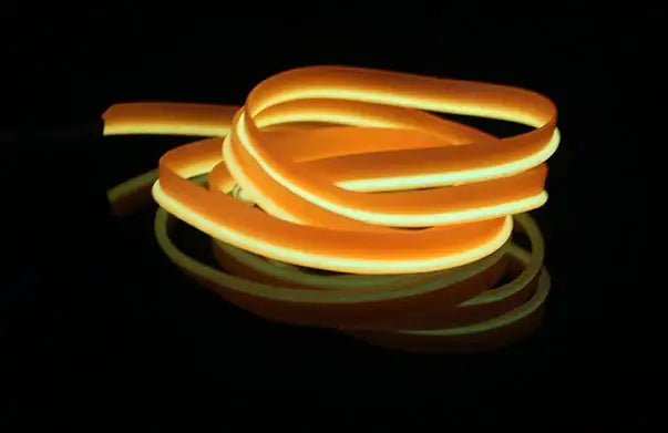 Coiled glowing orange LED neon rope light on a dark background.