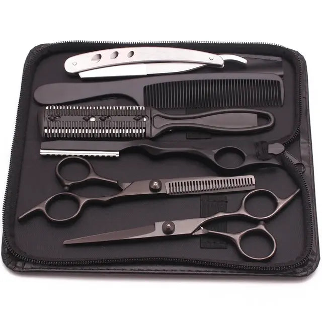 Haircutting tool kit in a zippered case, including two silver hair scissors (one thinning shears), a black comb, and a rainbow-finish straight razor, arranged on a black interior.