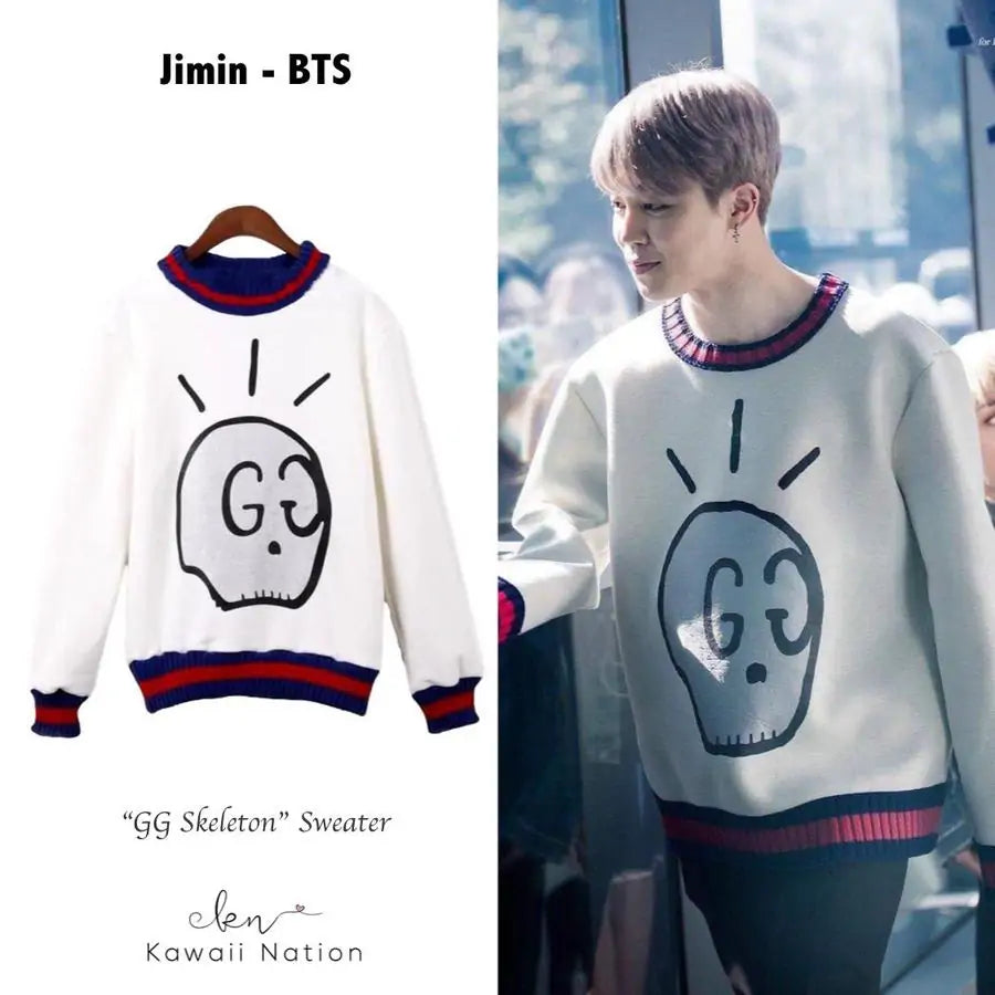 White GG skull graphic sweater with striped cuffs and hem.
