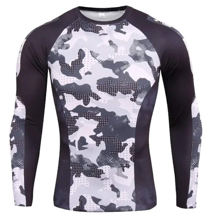 A long-sleeved athletic compression shirt with a gray, black, and white camouflage pattern on the front and sleeves. The shirt has black side panels and raglan-style sleeves, giving it a sporty and fitted design. The fabric appears to be stretchy and moisture-wicking, suitable for workouts or outdoor activities.