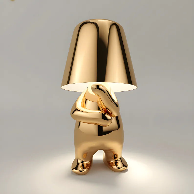 Gold animal-shaped table lamp with glossy finish and matching lampshade.
