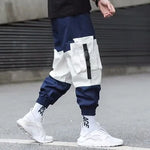 Navy and white cargo joggers with large utility pockets and elastic cuffs.
