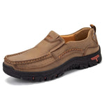 Tan slip-on outdoor loafers with contrast stitching, cushioned collar and rugged black sole.
