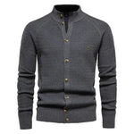 A sophisticated knitted cardigan with a mandarin collar and a button-up front. The cardigan features a textured pattern, ribbed cuffs and hem, and brown-toned buttons that add a stylish contrast. A small embroidered logo is visible on the left chest, enhancing its elegant design