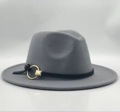 Gray felt fedora with a wide brim, shown on a white background, featuring a black band and a small gold ring-and-star charm on the side.