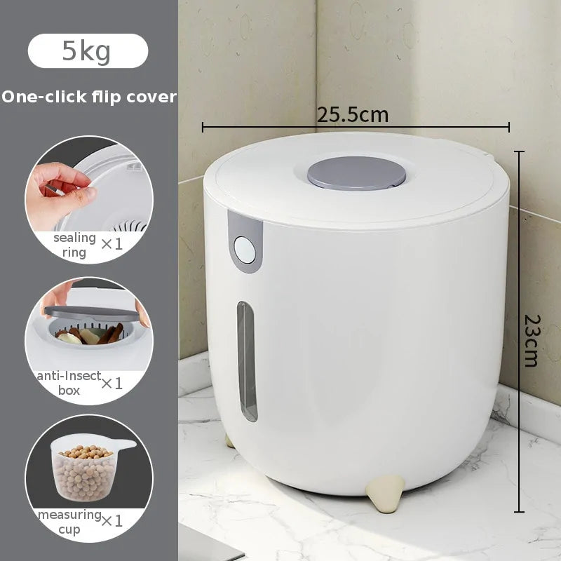 A white 5kg airtight food storage container with a one-click flip lid, shown on a countertop with labeled dimensions (25.5 cm wide, 23 cm tall). Side icons show included accessories: a sealing ring, an anti-insect box, and a measuring cup.