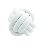 Soft white plush cushion shaped like a knotted ball, photographed on a white background.