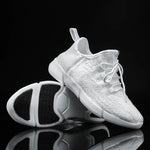 White lace-up trainers with textured uppers and chunky segmented soles.
