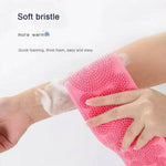 Hand scrubs a forearm with a pink silicone bristle wash mitt, creating soap suds; text reads “Soft bristle” and “Quick foaming, thick foam, easy and easy.