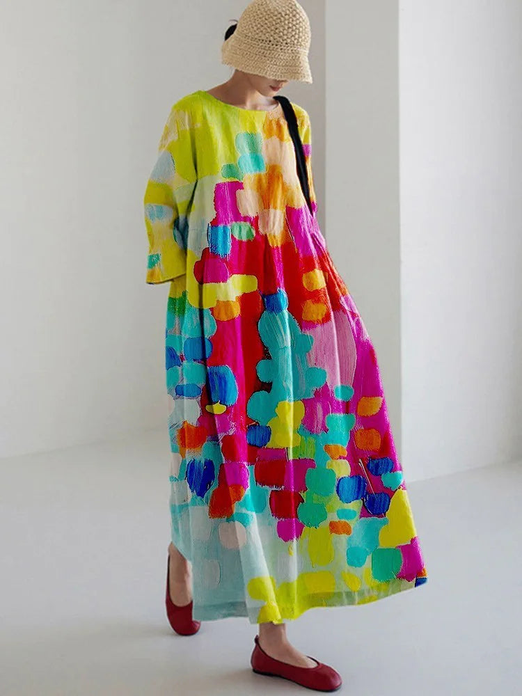 Woman wearing a loose-fitting, white midi dress with short sleeves, featuring bold red-orange floral prints accented with blue centers, paired with flat sandals.