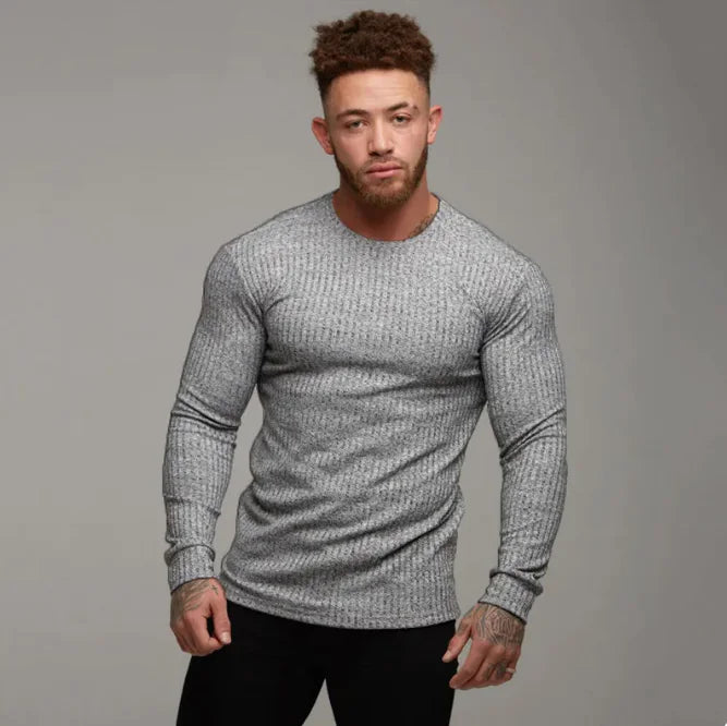 A stylish two-piece men's tracksuit. The set includes a hooded sweatshirt with a kangaroo pocket and long gray sleeves, along with matching jogger pants that have a drawstring waist and gray side panels with zippered pockets. The design offers a sporty yet casual look, ideal for workouts or everyday wear.