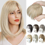 Blonde bob wig with side-swept bangs shown on a model, alongside a matching clip-in bangs/topper piece held in hands and small thumbnail images showing other color options.