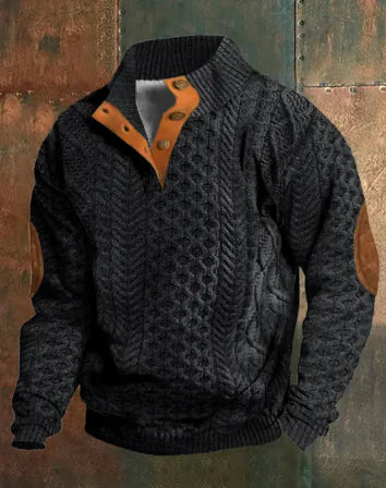 A dark brown men's pullover sweater with a textured cable knit pattern on the front. The sweater features a high ribbed collar with tan brown buttoned detailing, ribbed cuffs and hem, and matching tan elbow patches. The background consists of distressed, multicolored metal panels.