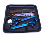 Open black zippered case containing a hair-cutting kit with two blue scissors (one thinning shear), an iridescent straight razor, and two combs arranged in elastic slots.